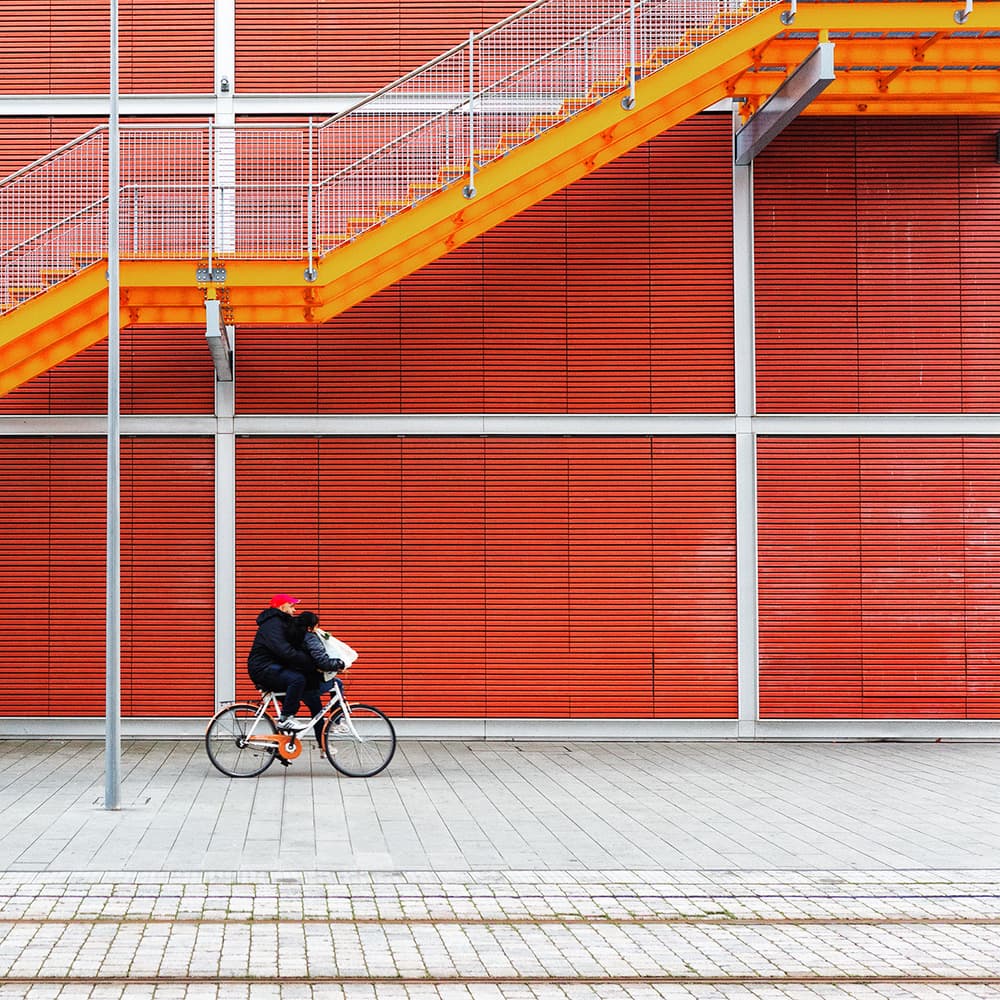 Red Wall Cyclist by Massimo Della Latta — canvas wall art