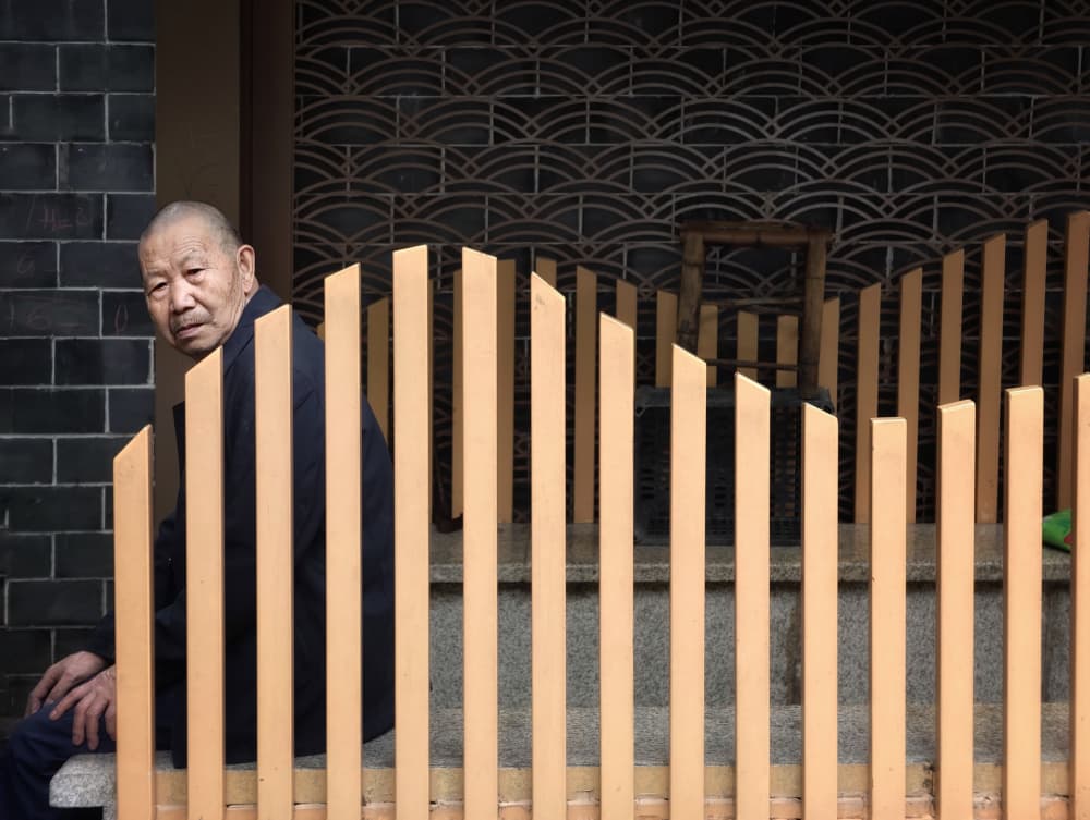 Asian Man Behind Fence by Jasmine Zhang — canvas wall art