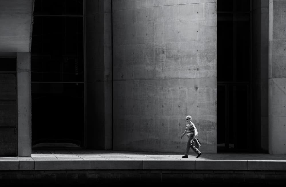 Man Walking Concrete Wall by Julien Oncete — canvas wall art