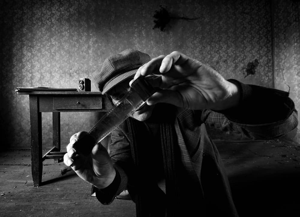 Man Inspecting Vintage Film by mario grobenski - psychodaddy — canvas wall art