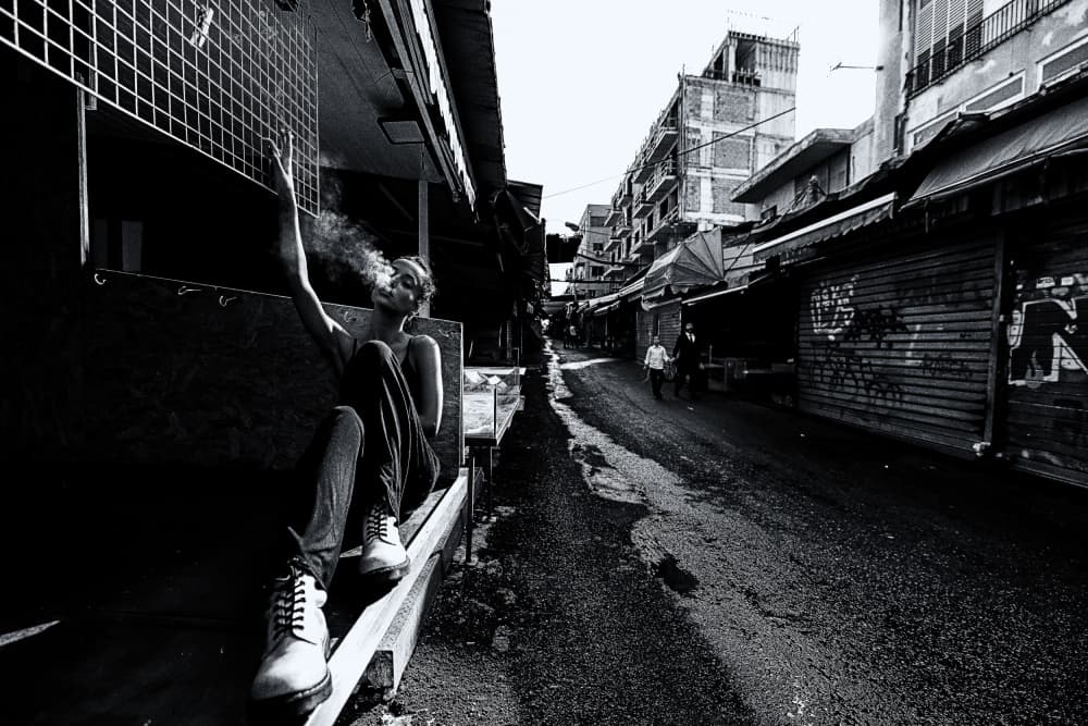 Man Smoking in Urban Alley by Amnon Eichelberg — canvas wall art