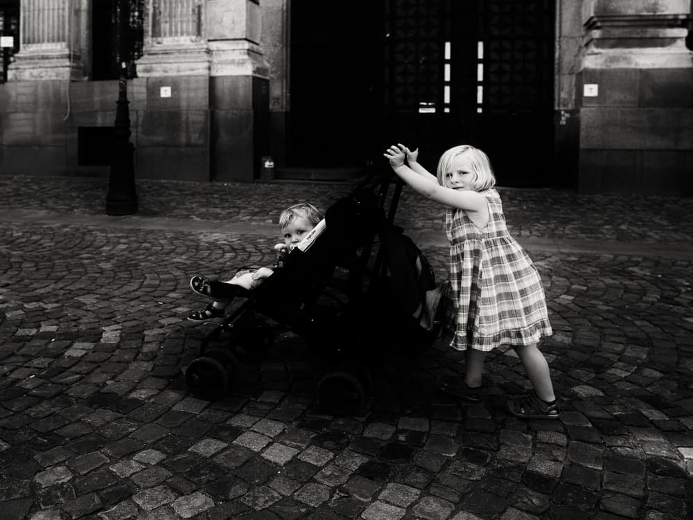 Little Girl Pushes Stroller by Julien Oncete — canvas wall art