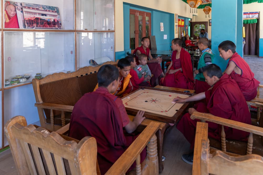 Young Monks Playing Carrom by Ilana Lam — canvas wall art
