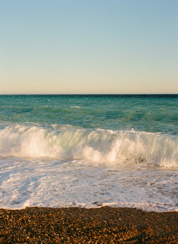Turquoise Waves Pebble Beach by Bethany Young — canvas wall art