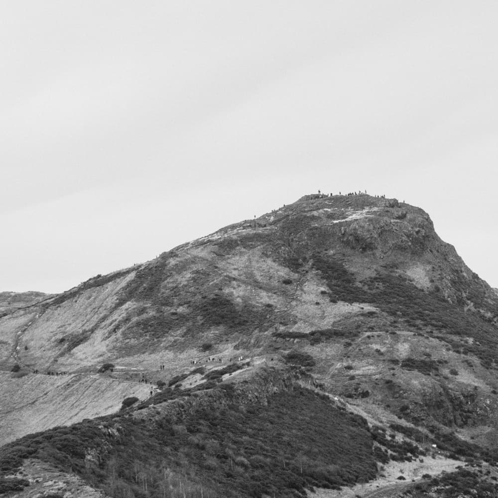 Hikers on Mountain Peak by Lynann Colligan — canvas wall art