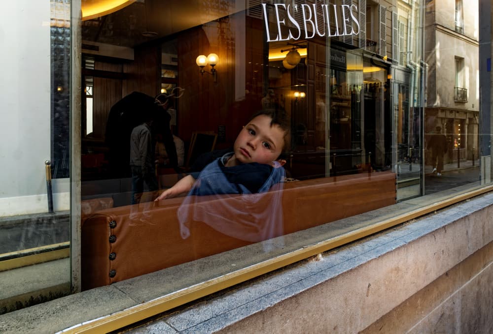 Young Boy Cafe Window by John Hoey — canvas wall art