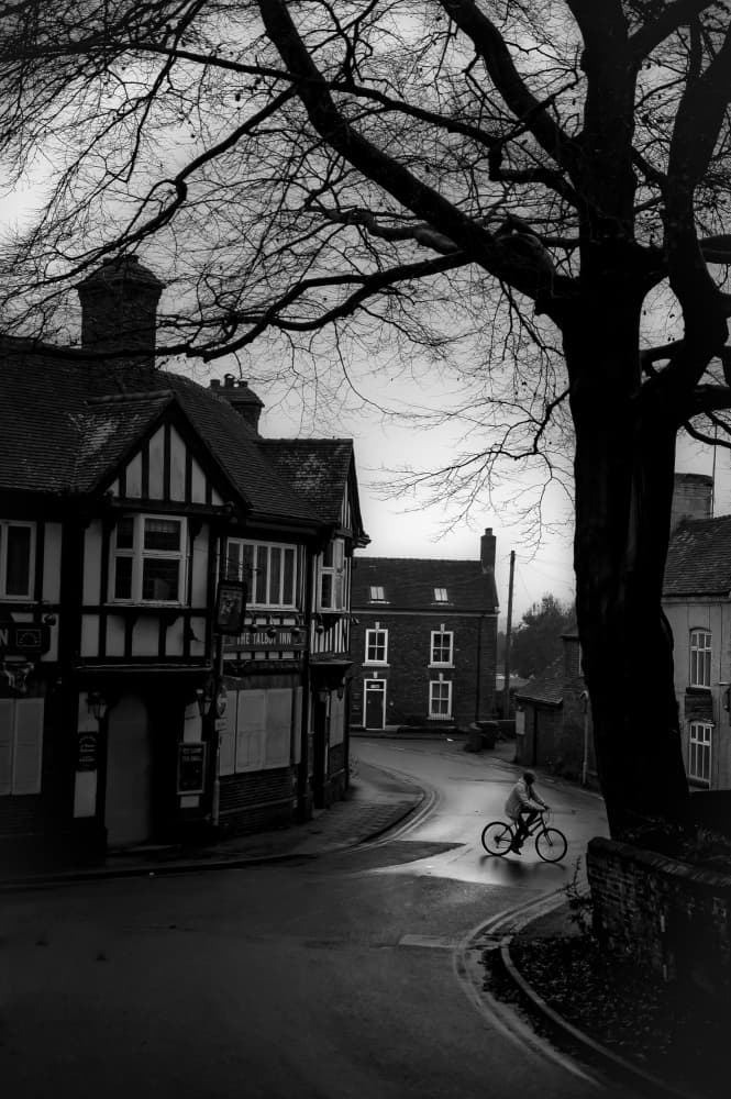 Cyclist On Wet Village Street by Amer Jassim — canvas wall art