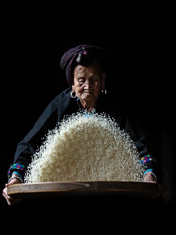 Elderly Woman Sifting Rice by Amnon Eichelberg — canvas wall art