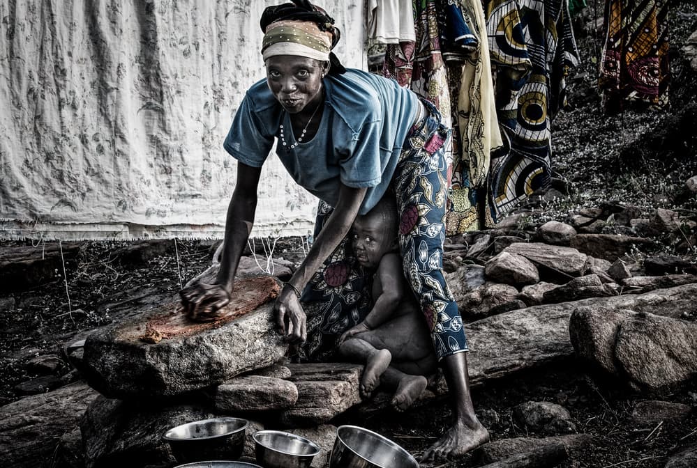 African Mother Grinding by Joxe Inazio Kuesta Garmendia — canvas wall art