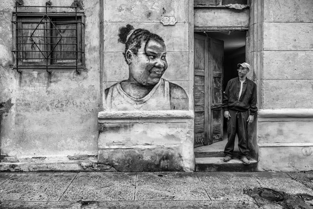 Man Beside Wall Mural by Marco Tagliarino — canvas wall art