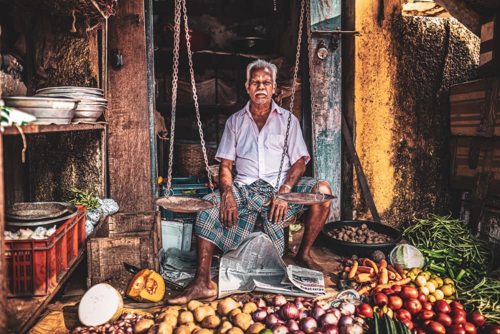 Elderly Market Vendor by Marco Tagliarino — canvas wall art