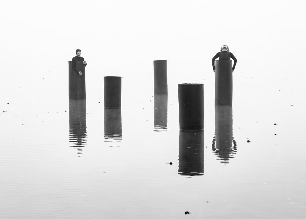 Misty Figures on Pillars by Leszek Paradowski — canvas wall art
