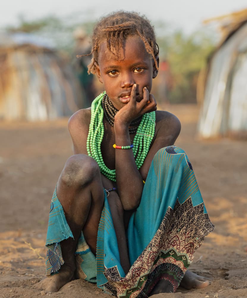 African Child Direct Gaze by Hamza Qarooni — canvas wall art
