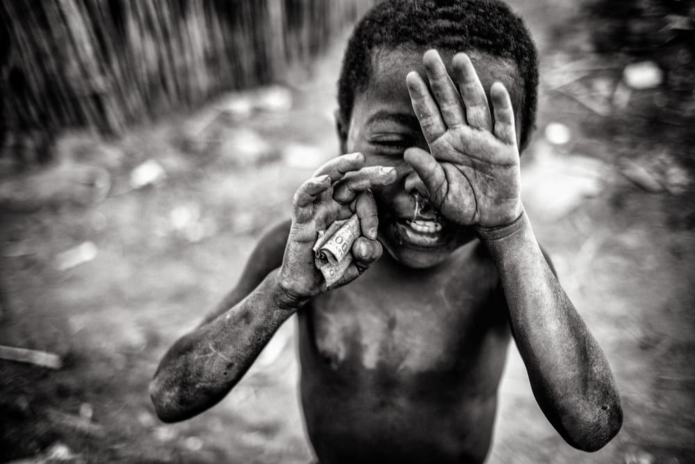 Boy Holding Crumpled Money by Marco Tagliarino — canvas wall art